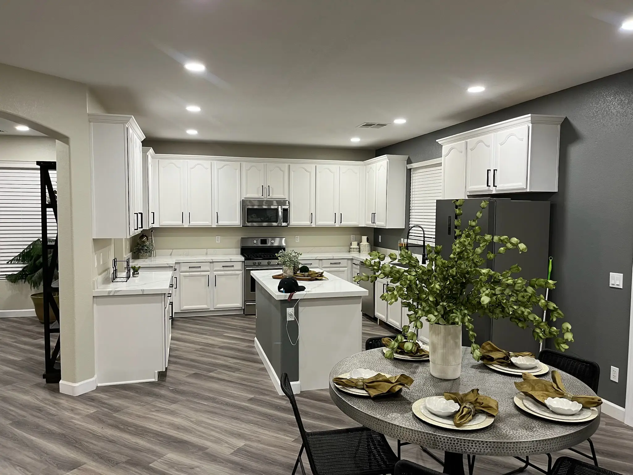 Bright kitchen remodel with white cabinets and dining table